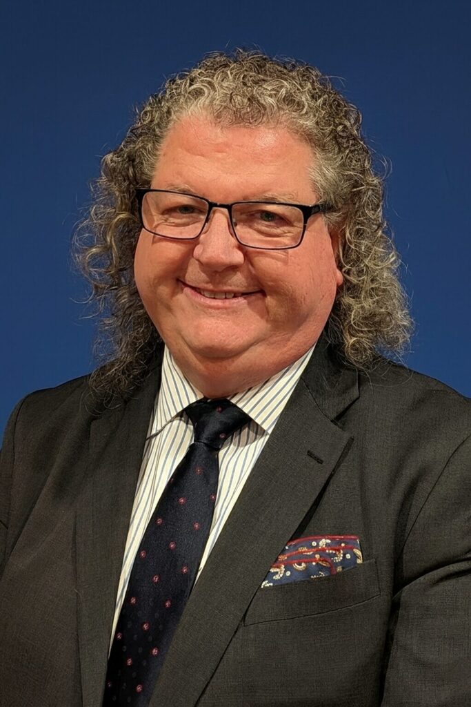 HeadShot1 Man in suit with curly hair